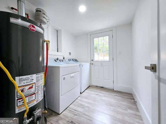 2400 Glenrock Dr, Decatur, GA 30032 - clothes washing area with water heater, washing machine and dryer, light wood finished floors, and baseboards