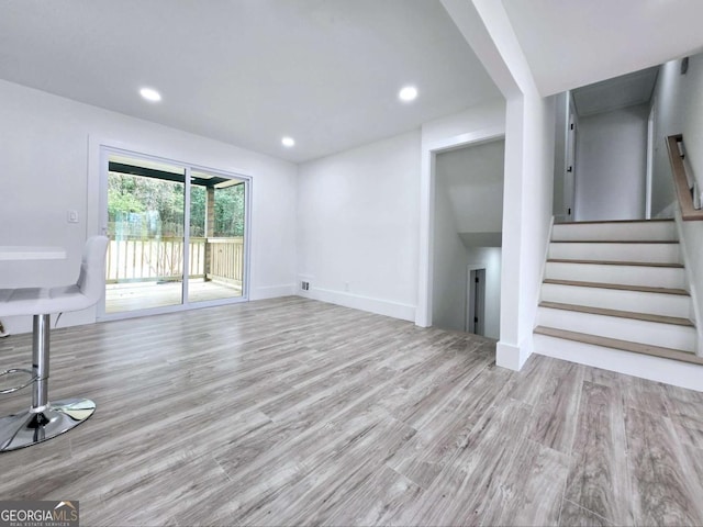 2400 Glenrock Dr, Decatur, GA 30032 - unfurnished living room featuring wood finished floors, stairs, recessed lighting, and baseboards