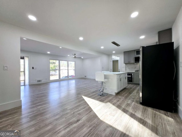 2400 Glenrock Dr, Decatur, GA 30032 - kitchen with appliances with stainless steel finishes, recessed lighting, light countertops, ceiling fan, and a breakfast bar