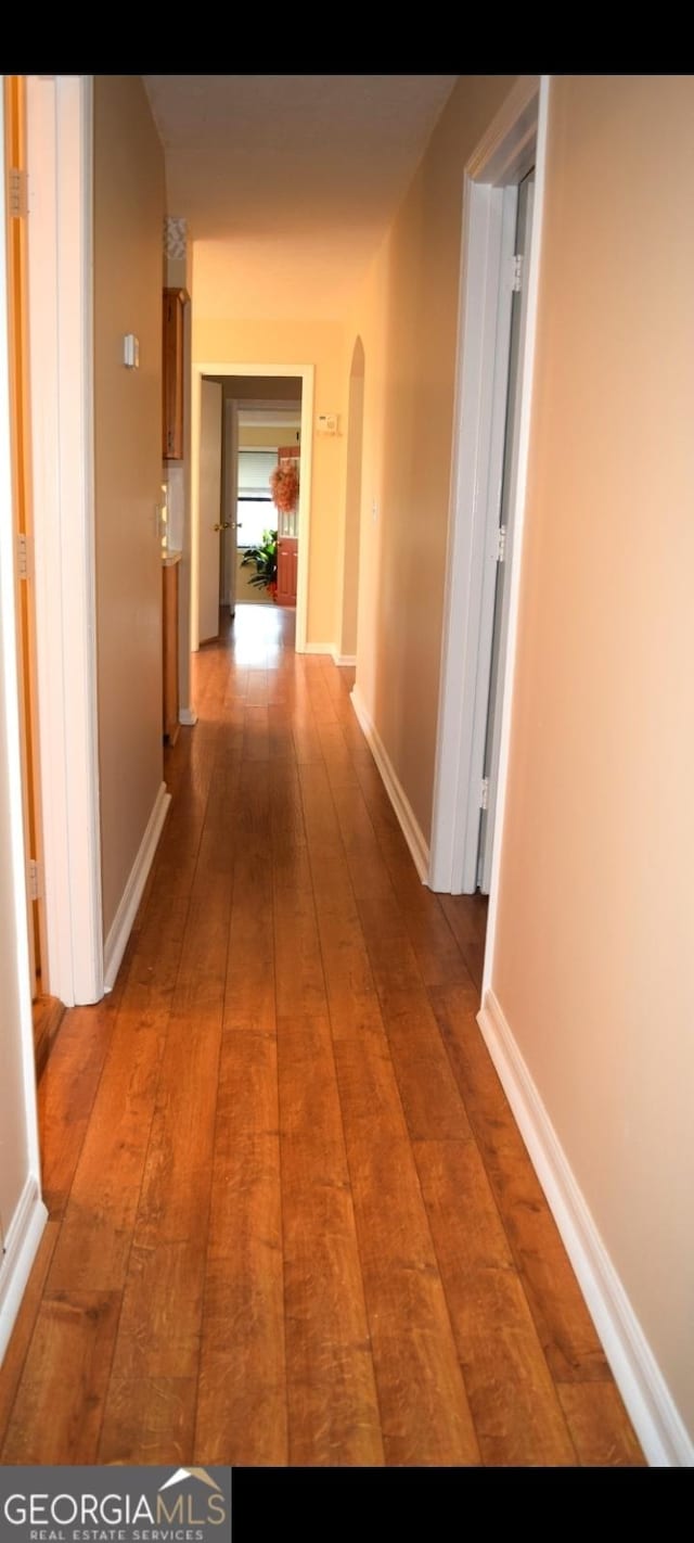 5802 Blueridge Dr, Columbus, GA 31907 - hallway featuring arched walkways, hardwood / wood-style floors, and baseboards
