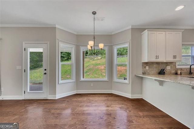 47 Whitley Ct, Dallas, GA 30157 - unfurnished dining area with dark wood-style flooring, ornamental molding, a chandelier, baseboards, and a sink
