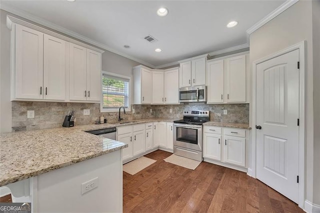 47 Whitley Ct, Dallas, GA 30157 - kitchen with appliances with stainless steel finishes, crown molding, a sink, white cabinetry, and recessed lighting