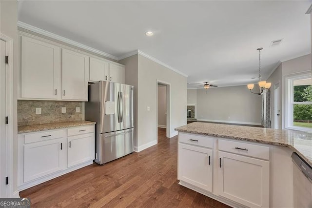 47 Whitley Ct, Dallas, GA 30157 - kitchen with stainless steel appliances, backsplash, crown molding, white cabinets, and a chandelier