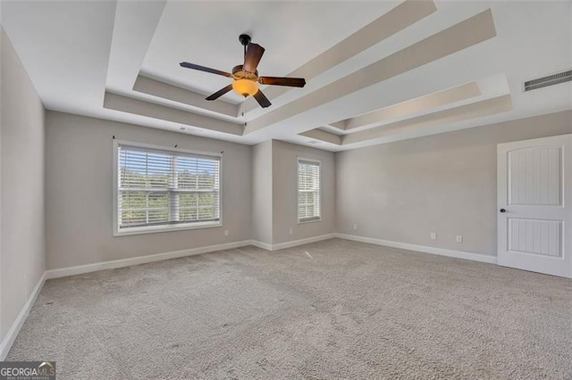 47 Whitley Ct, Dallas, GA 30157 - spare room featuring a tray ceiling, carpet flooring, ceiling fan, and baseboards
