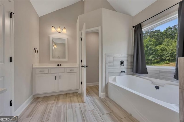 47 Whitley Ct, Dallas, GA 30157 - full bathroom with lofted ceiling, a garden tub, baseboards, and vanity