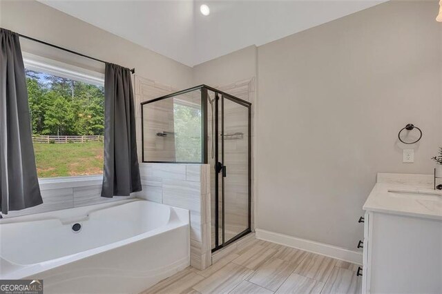 47 Whitley Ct, Dallas, GA 30157 - bathroom with a tub, a shower stall, vanity, and baseboards