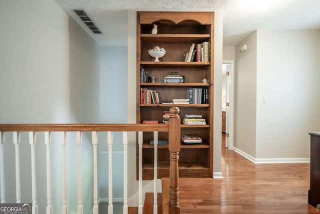 hall with wood finished floors and baseboards