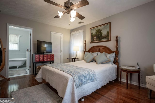 bedroom with wood finished floors, baseboards, ceiling fan, and ensuite bathroom