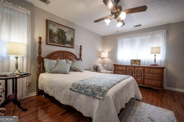bedroom featuring baseboards, dark wood-type flooring, and ceiling fan