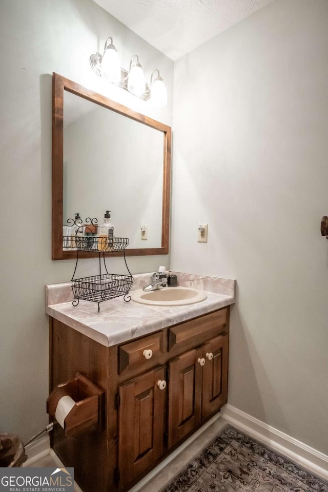 bathroom with vanity and baseboards