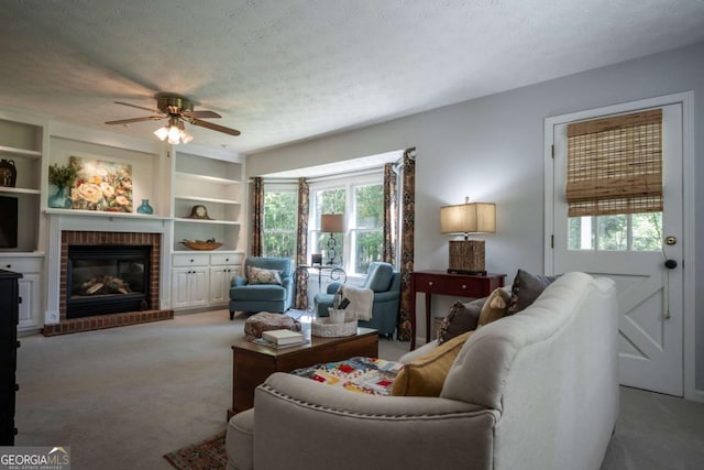 living area featuring healthy amount of natural light, a ceiling fan, light colored carpet, and a textured ceiling