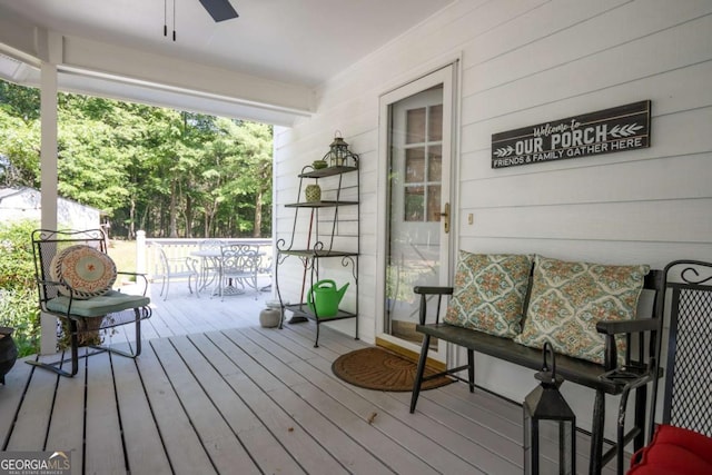 deck featuring a ceiling fan and outdoor dining space