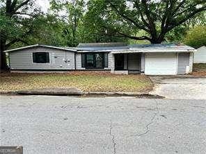 2135 Wells Dr SE, Smyrna, GA 30080 - view of front of house featuring an attached garage and driveway