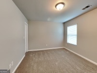 620 Sedona Loop, Hampton, GA 30228 - unfurnished room featuring baseboards and carpet