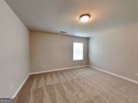 620 Sedona Loop, Hampton, GA 30228 - carpeted empty room featuring baseboards