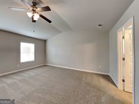 620 Sedona Loop, Hampton, GA 30228 - carpeted spare room featuring baseboards, lofted ceiling, and a ceiling fan