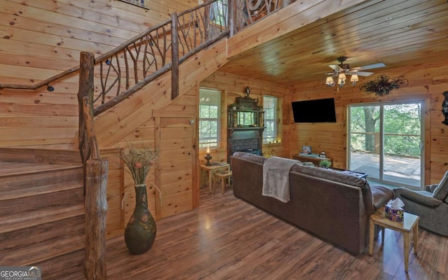315 Call Wright Rd, Ellijay, GA 30540 - living area with wooden walls, wood finished floors, healthy amount of natural light, ceiling fan, and a fireplace