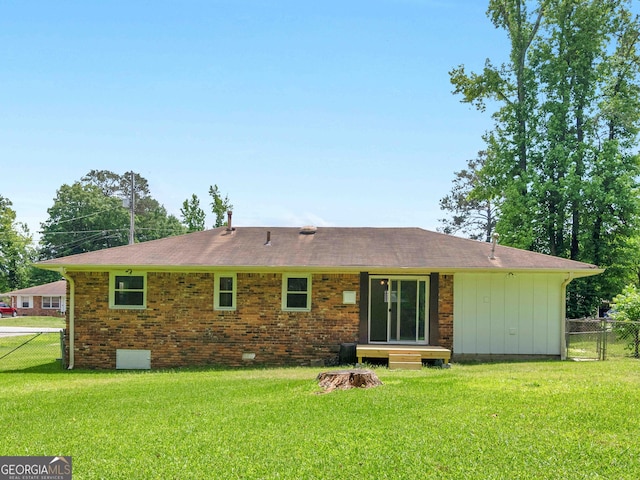 back of house featuring a shingled roof