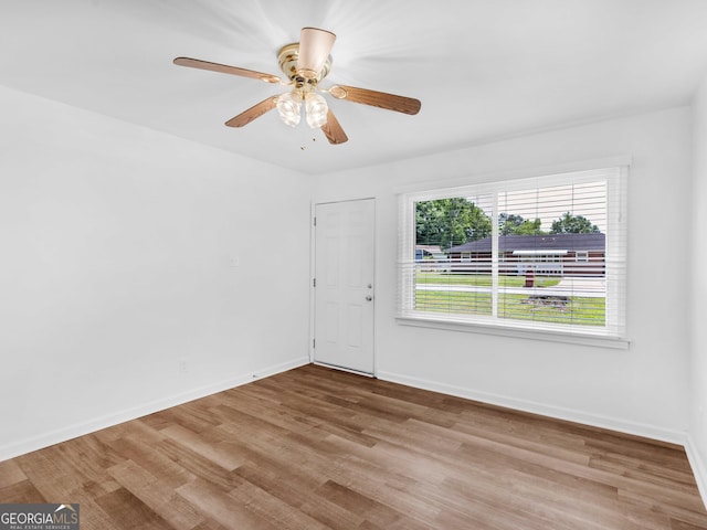empty room featuring wood finished floors and baseboards