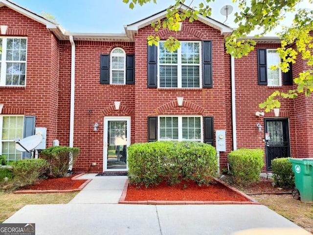 townhome / multi-family property featuring brick siding