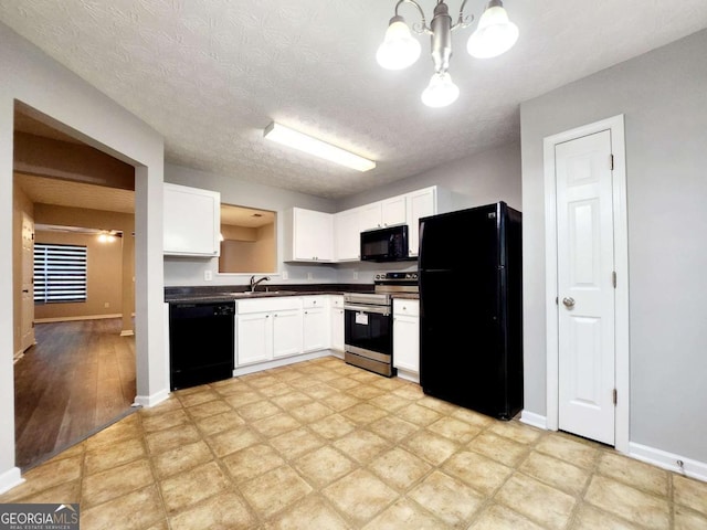 kitchen featuring black appliances, white cabinetry, dark countertops, a chandelier, and a sink
