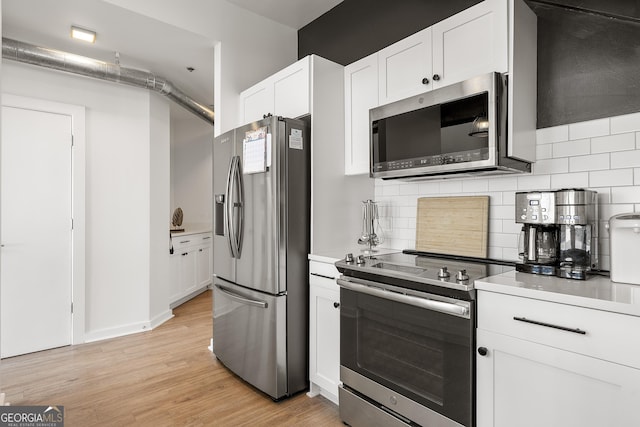 260N 18th St Unit 10326, Atlanta, GA 30363 - kitchen with stainless steel appliances, tasteful backsplash, light countertops, and light wood-type flooring