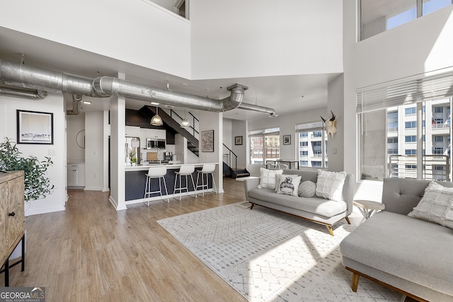 260N 18th St Unit 10326, Atlanta, GA 30363 - living area featuring wood finished floors, stairway, and a high ceiling