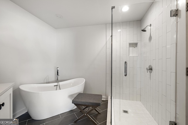 260N 18th St Unit 10326, Atlanta, GA 30363 - full bathroom featuring a shower stall, a freestanding tub, tile patterned flooring, recessed lighting, and vanity