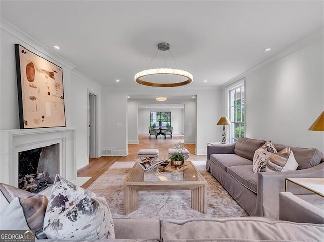 3625 Tuxedo Rd NW, Atlanta, GA 30305 - living room with light wood finished floors, crown molding, a fireplace with flush hearth, recessed lighting, and baseboards