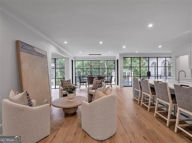 3625 Tuxedo Rd NW, Atlanta, GA 30305 - living area featuring light wood-style flooring, recessed lighting, plenty of natural light, and ornamental molding