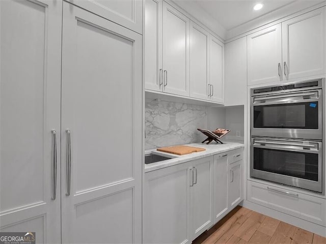3625 Tuxedo Rd NW, Atlanta, GA 30305 - kitchen with stainless steel double oven, white cabinets, light countertops, recessed lighting, and light wood-style flooring