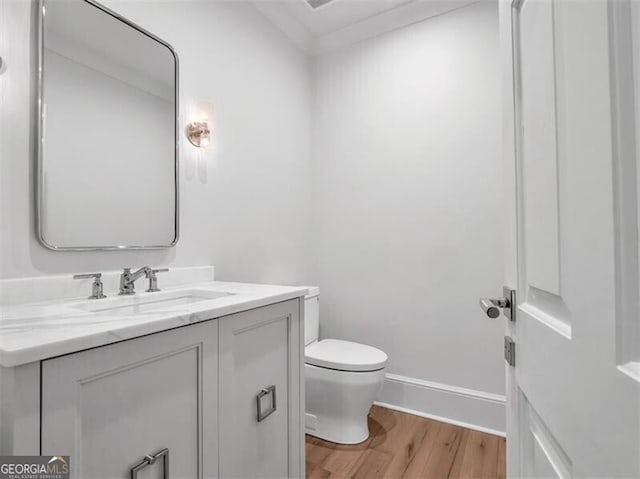 3625 Tuxedo Rd NW, Atlanta, GA 30305 - half bathroom featuring wood finished floors, toilet, vanity, and baseboards