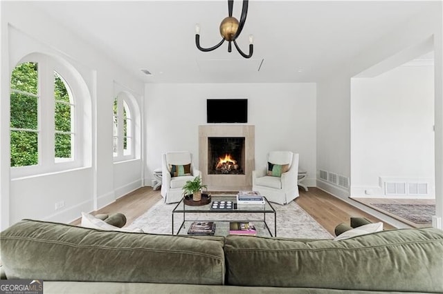 3625 Tuxedo Rd NW, Atlanta, GA 30305 - living room featuring wood finished floors, baseboards, a fireplace, and a chandelier