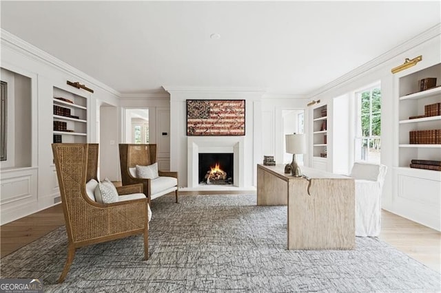 3625 Tuxedo Rd NW, Atlanta, GA 30305 - living area featuring built in features, crown molding, a warm lit fireplace, and wood finished floors