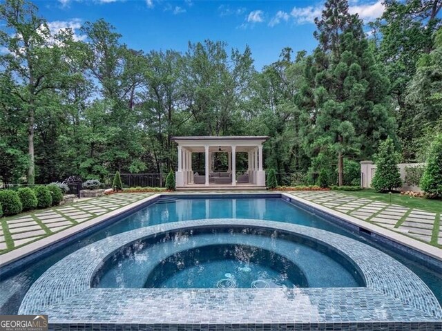 3625 Tuxedo Rd NW, Atlanta, GA 30305 - view of swimming pool with a pool with connected hot tub, a gazebo, and view of wooded area