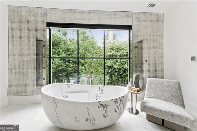 3625 Tuxedo Rd NW, Atlanta, GA 30305 - bathroom featuring a soaking tub and baseboards