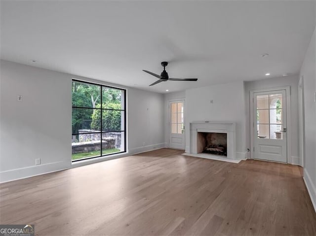 3625 Tuxedo Rd NW, Atlanta, GA 30305 - unfurnished living room with wood finished floors, baseboards, plenty of natural light, and recessed lighting