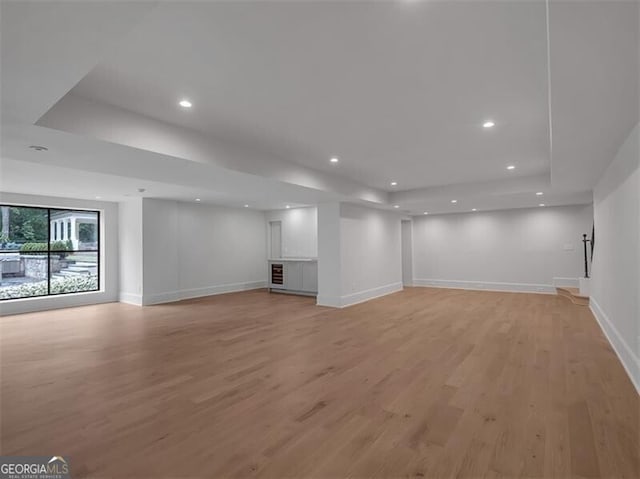 3625 Tuxedo Rd NW, Atlanta, GA 30305 - unfurnished living room with a tray ceiling, baseboards, light wood-type flooring, and recessed lighting
