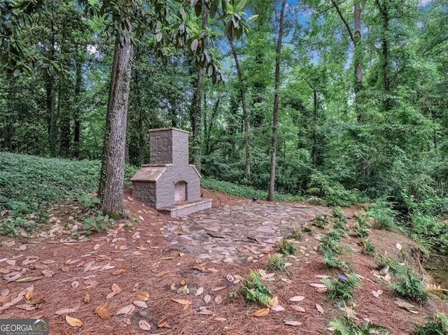 3625 Tuxedo Rd NW, Atlanta, GA 30305 - view of yard featuring exterior fireplace and a view of trees