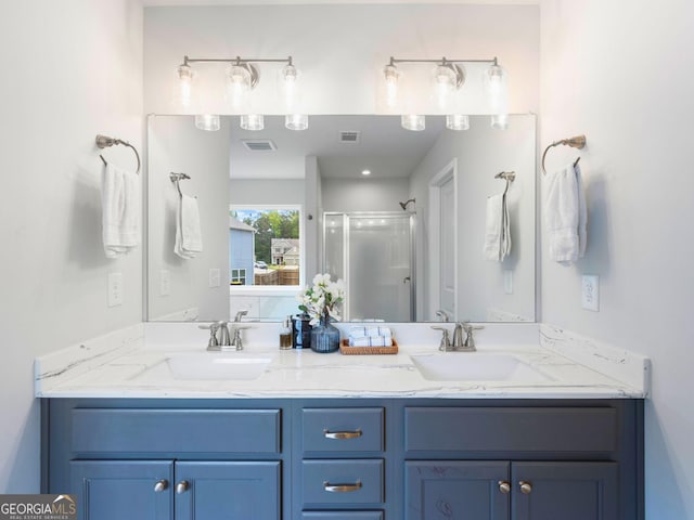 full bath featuring a stall shower and double vanity