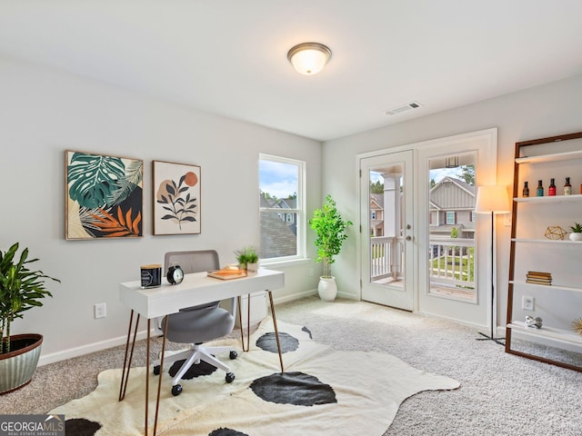 carpeted office space featuring baseboards and french doors