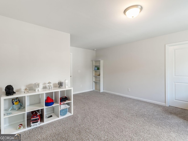 rec room featuring carpet and baseboards