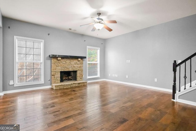 456 Crestmont Ln, Canton, GA 30114 - unfurnished living room with ceiling fan, stairway, wood finished floors, and a stone fireplace