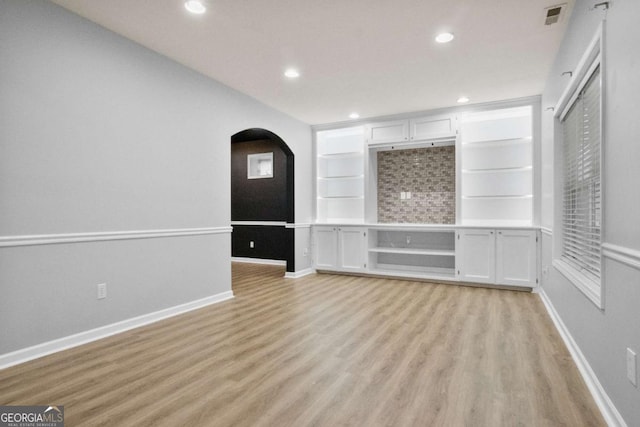 456 Crestmont Ln, Canton, GA 30114 - unfurnished room featuring light wood-type flooring, arched walkways, recessed lighting, and built in features