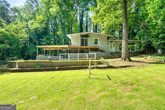 4882 Rock Haven Dr SW, Lilburn, GA 30047 - rear view of house featuring a lawn and view of scattered trees