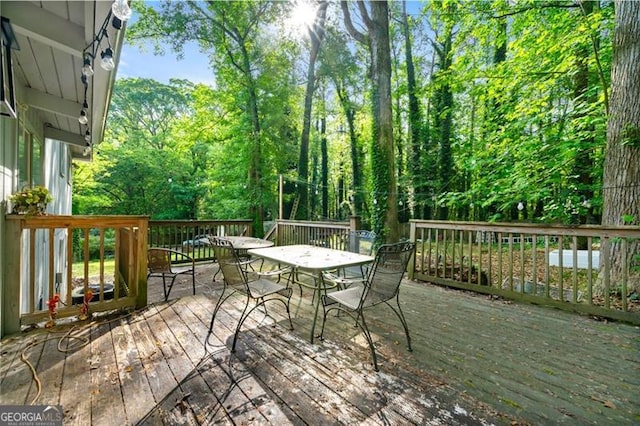4882 Rock Haven Dr SW, Lilburn, GA 30047 - wooden deck with outdoor dining space