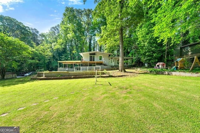 4882 Rock Haven Dr SW, Lilburn, GA 30047 - view of grassy yard featuring view of wooded area