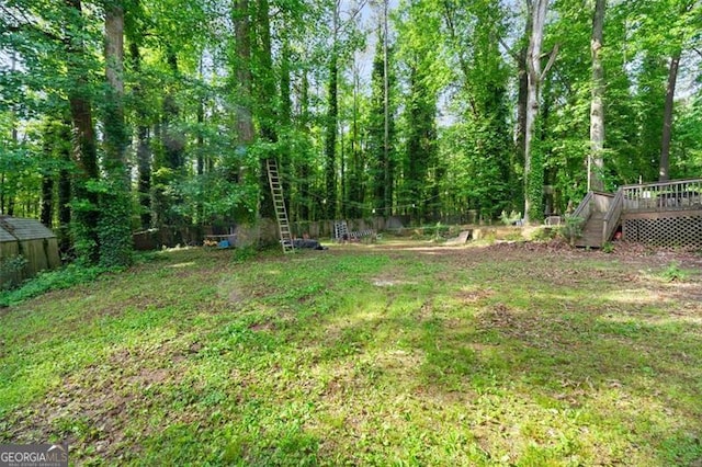 4882 Rock Haven Dr SW, Lilburn, GA 30047 - view of grassy yard with a deck
