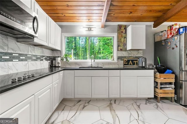 4882 Rock Haven Dr SW, Lilburn, GA 30047 - kitchen with a sink, wood ceiling, appliances with stainless steel finishes, light marble finish flooring, and white cabinets