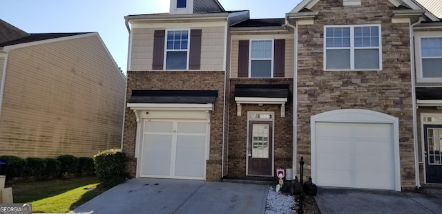 2102 Executive Dr, Duluth, GA 30096 - view of front facade with concrete driveway, an attached garage, and stone siding